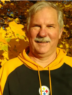 Brian Judd in a Steelers sweatshirt with yellow leave background